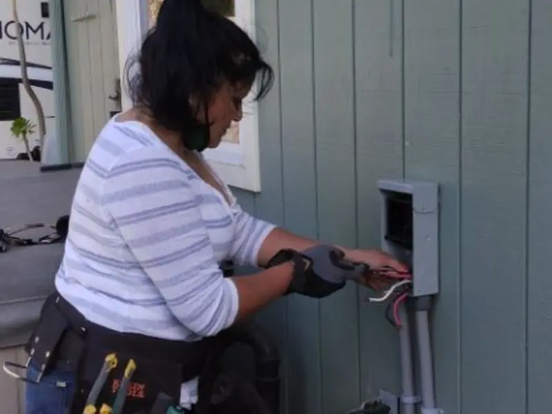 Licensed electrician wiring an exterior subpanel in Kent